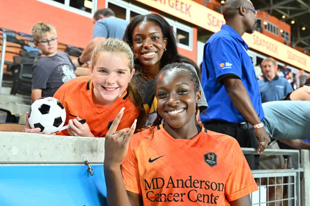 Michelle Alozie poses for a photograph with fans 