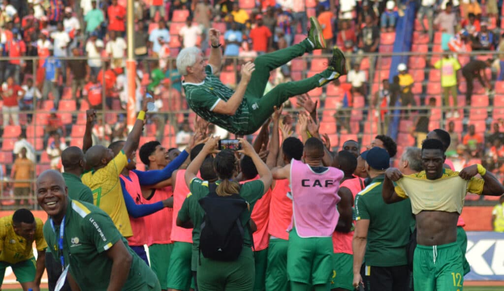 South Africa players celebrate victory and qualification with head coach Hugo Broos 